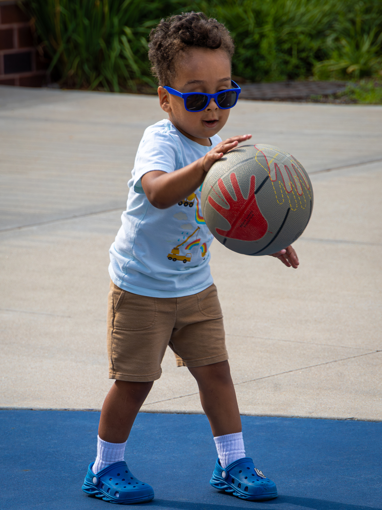 Child dribbling basektball.