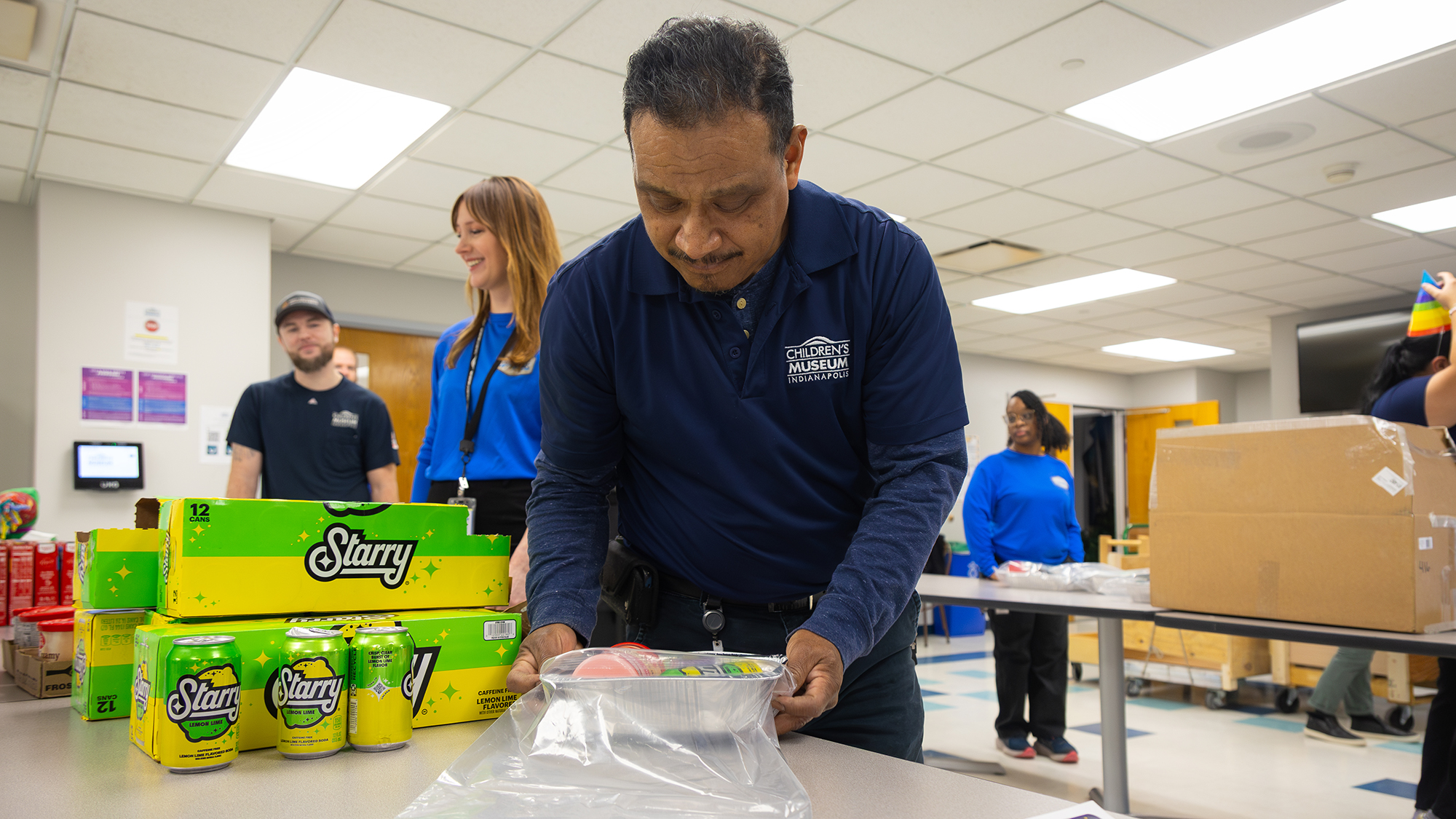 Museum staff member making cake donation kit.