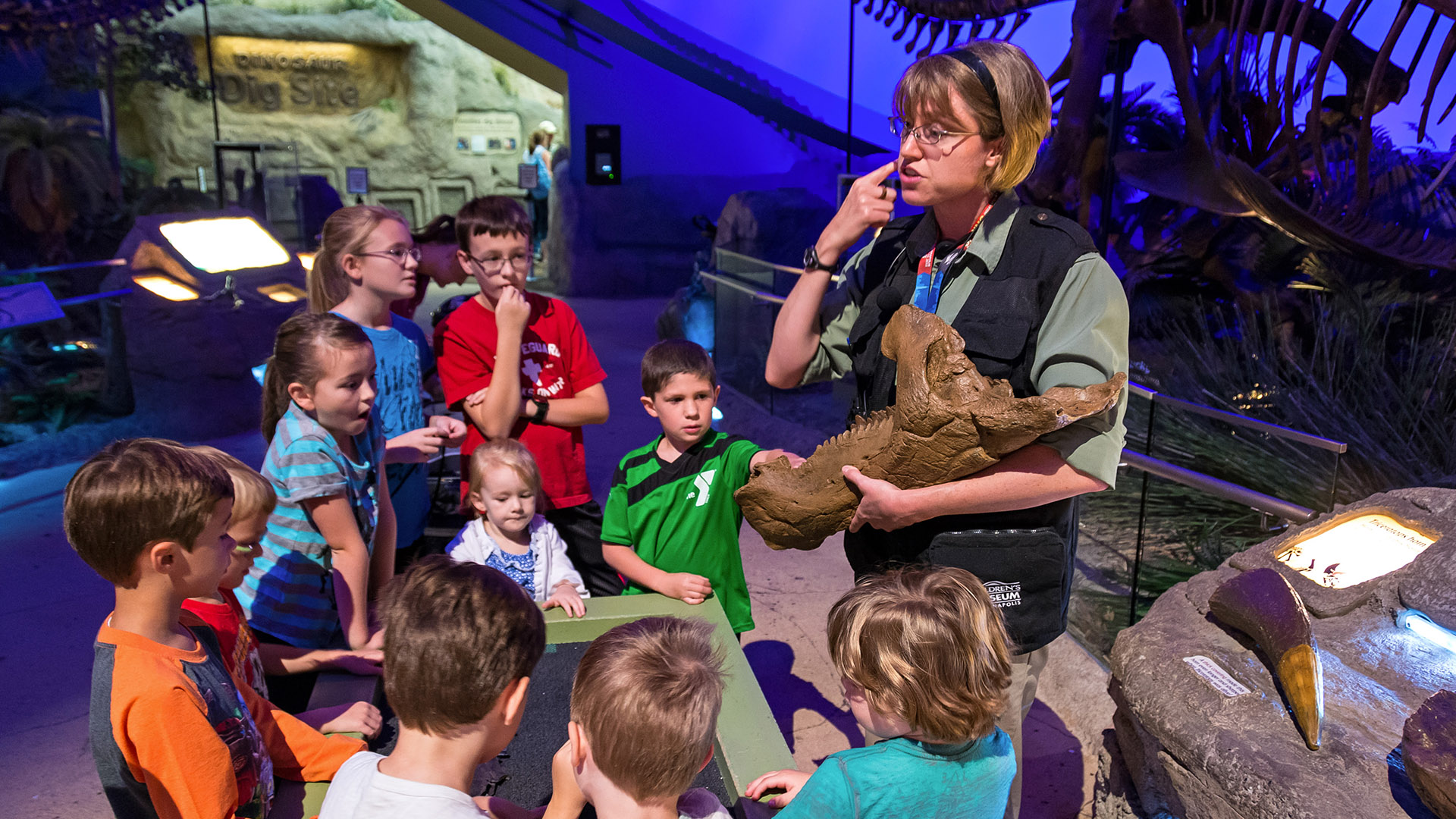 Staff member showing fossil to group.