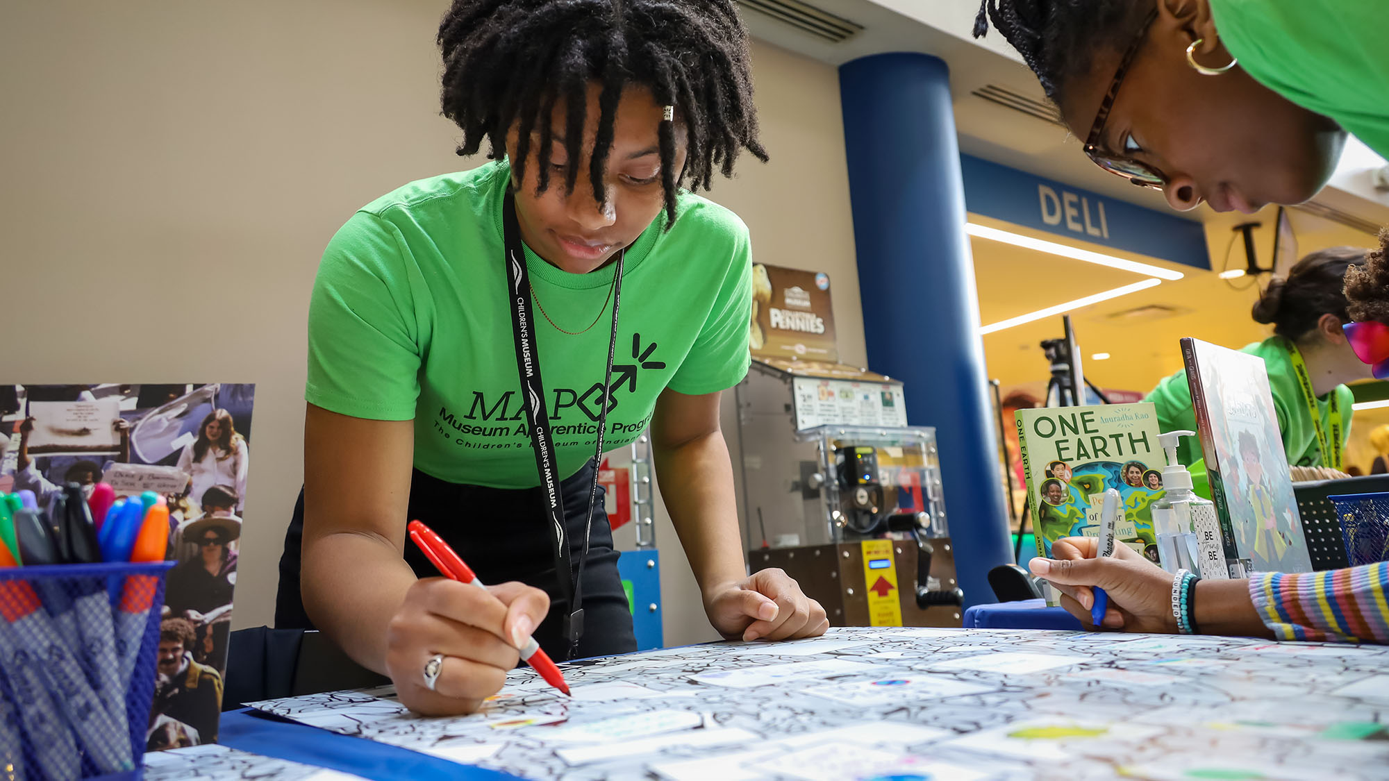 MAP participant writing on poster.