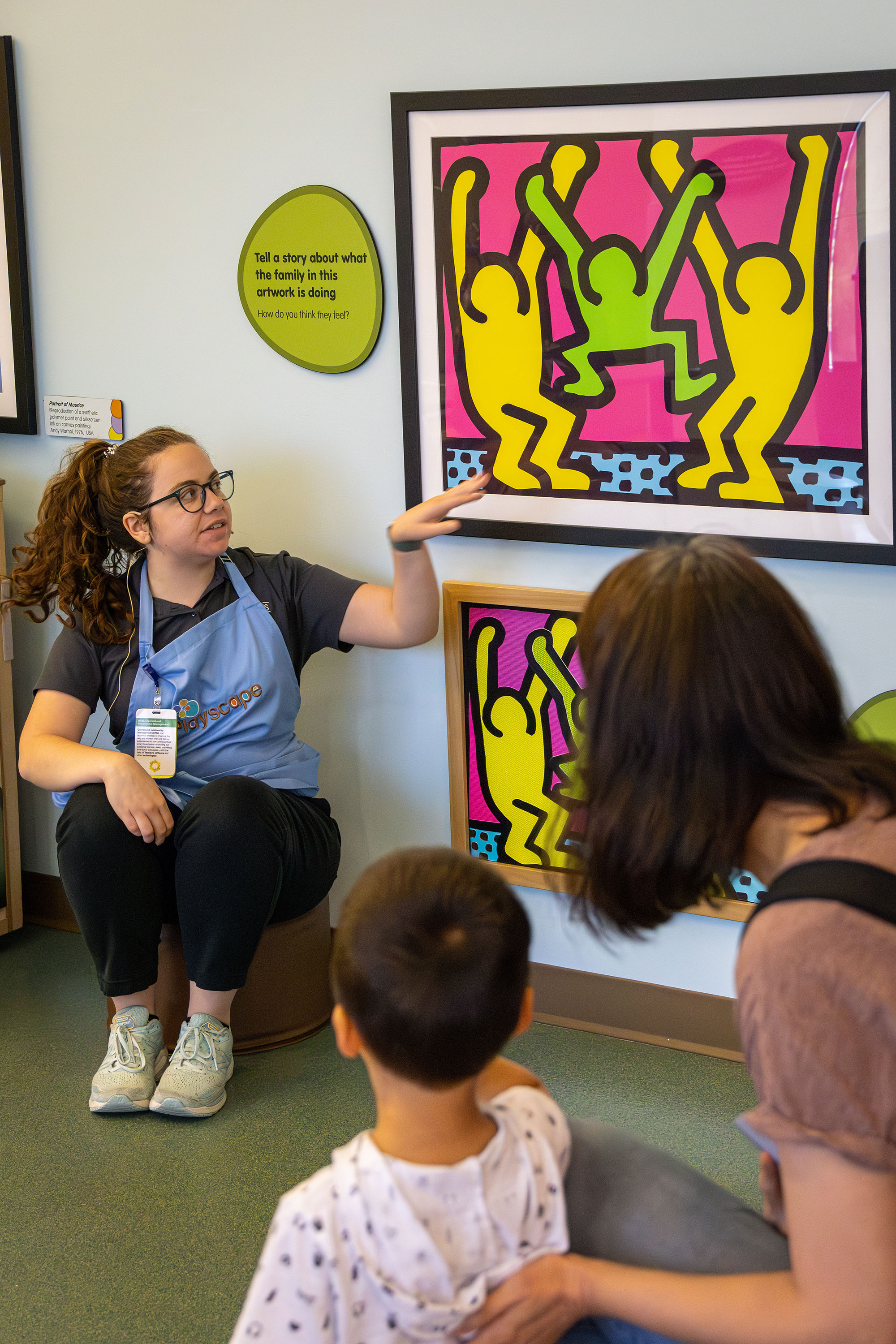 Staff member pointing at artwork.
