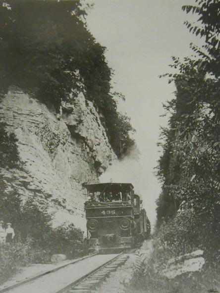 Historical photo of the Reuben Wells pushing a train up Madison Hill in Madison, IN