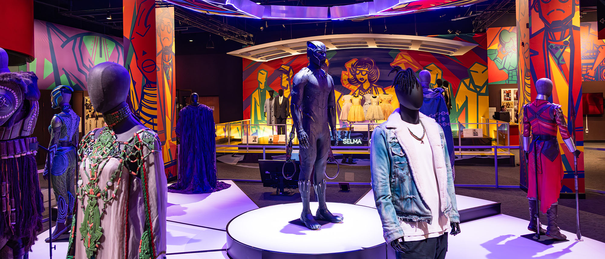 Costumes in the exhibit, including Black Panther, The Butler, and Malcolm X.