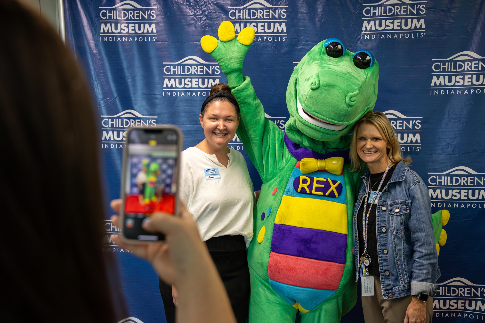 Teachers posing for a photo with Rex, the mascot.