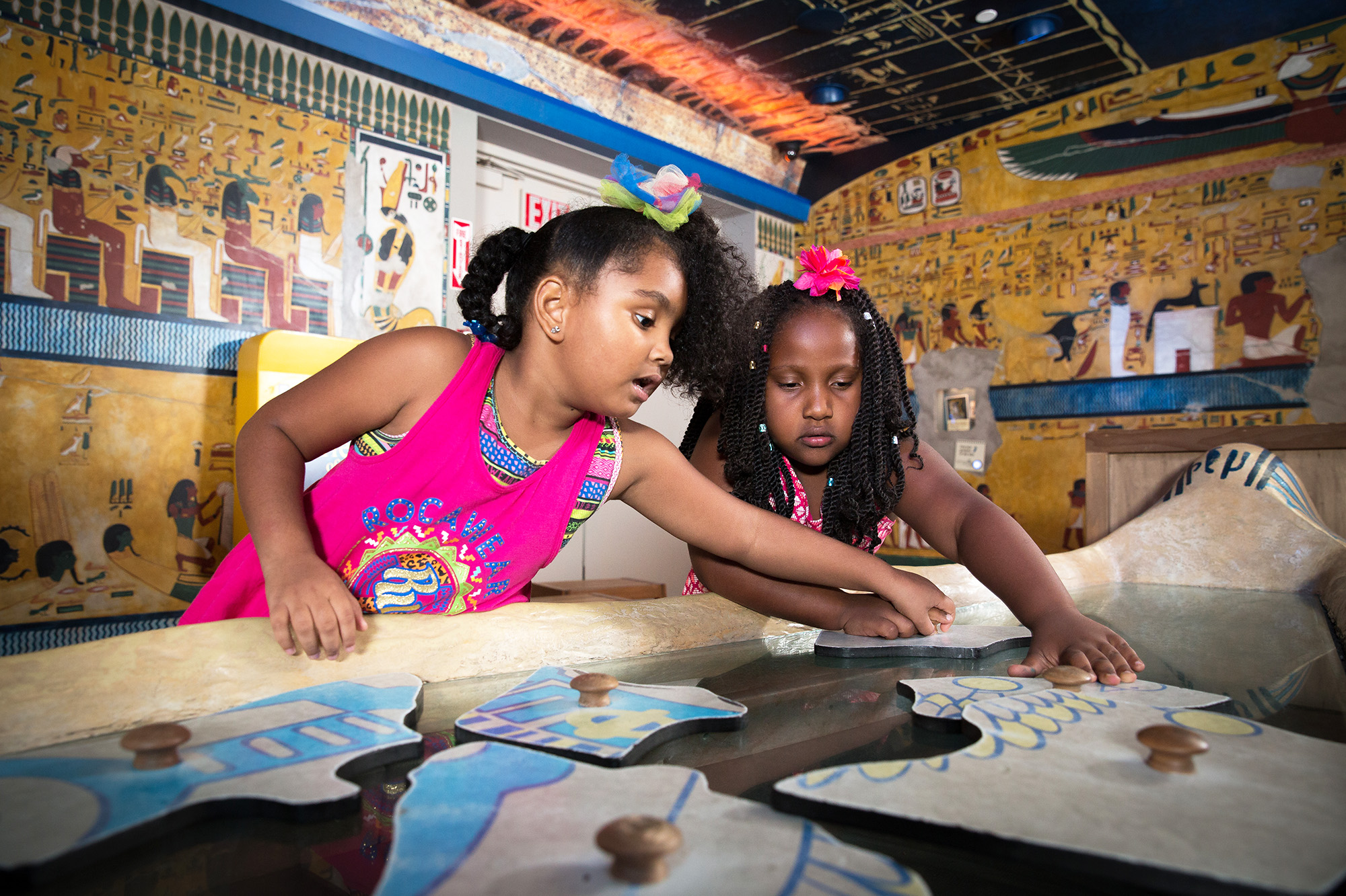 Children putting together large puzzle.